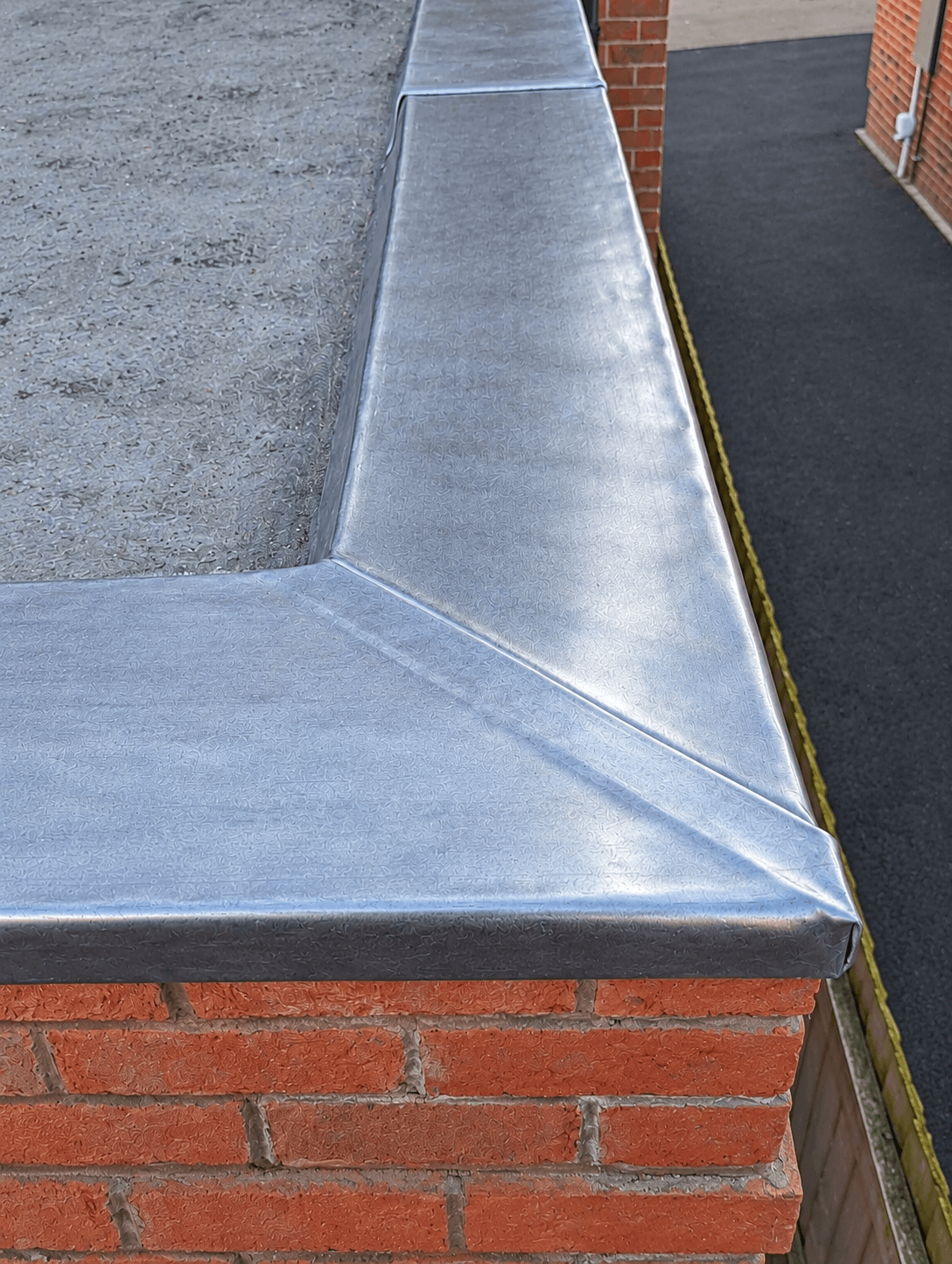 Detailed lead flashing on a parapet corner