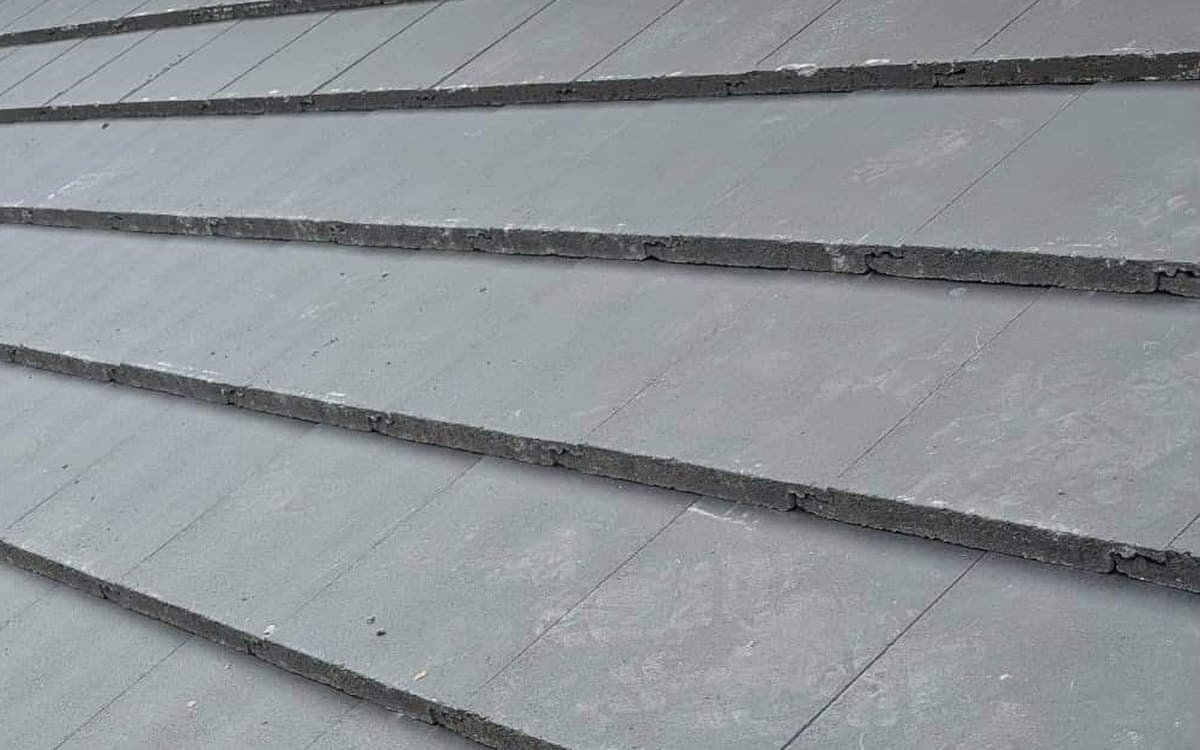 Close-up of new interlocking concrete tiles on a pitched roof